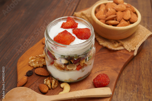 Breakfast with yogurt, granola and almonds, healthy food concept