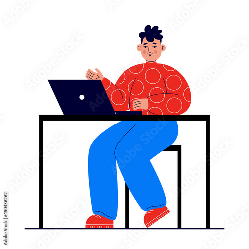 Young man sits at a table with a laptop. Distance learning concept, e-learning, remote work from home, freelance, courses. Student learns using a computer. (ID: 490336262)