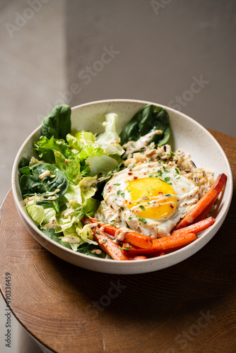 Plate with breakfast salads: brown rice, carrots, egg