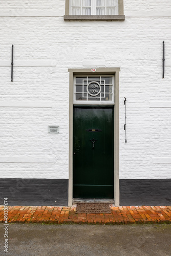 Hoogstraten, Belgium, 11 november 2021, UNESCO listed Beguinage of Hoogstraten, Belgium. The beautiful medieval Beguinage of Hoogstraten, showing the front door of one of the white houses. High photo