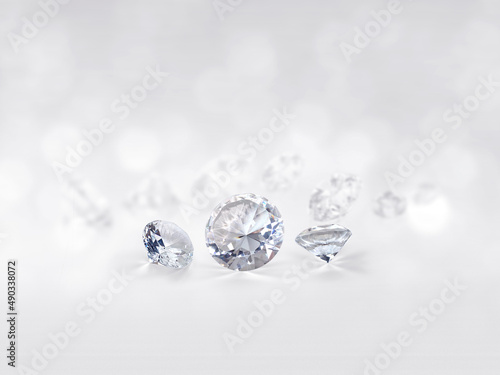 still with expensive cut diamonds in front of a white background, reflections on the ground. Lot of copyspace