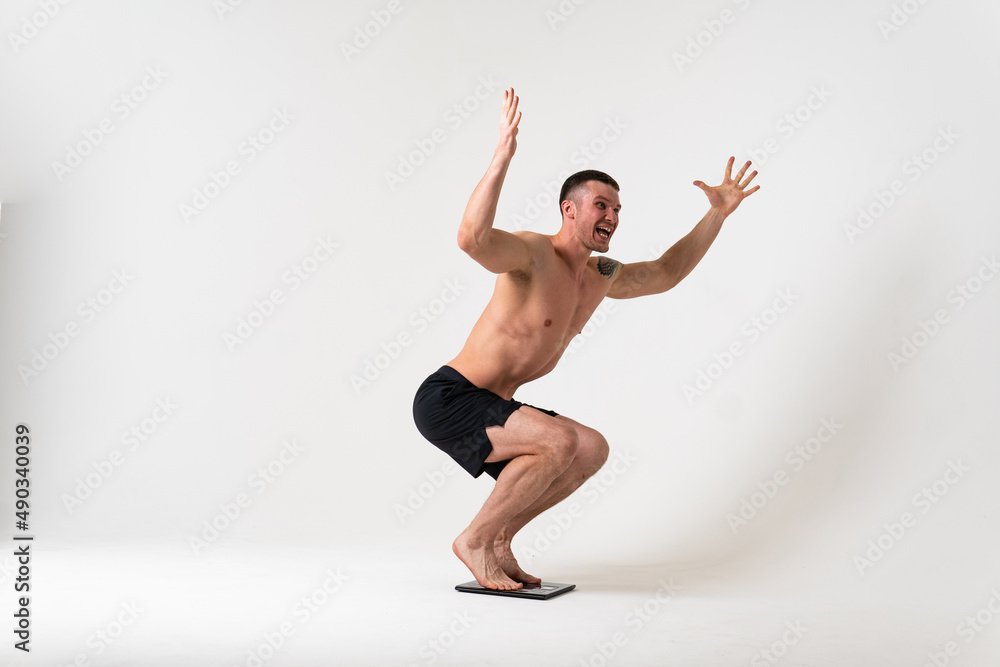 Man with weights health pondered, health and sports on a white background ache hurt injury, isolated massage illness expression. neck disease suffer attractive Man with weights health pondered, health and sports on a white background ache hurt injury, isolated massage illness expression. neck disease suffer attractive