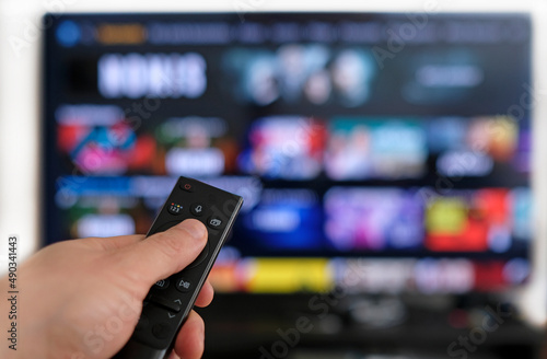 Remote control and screen - binge watching the favorite TV show