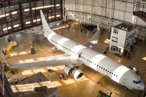 Fotografie Top view of a white passenger airplane in the hangar