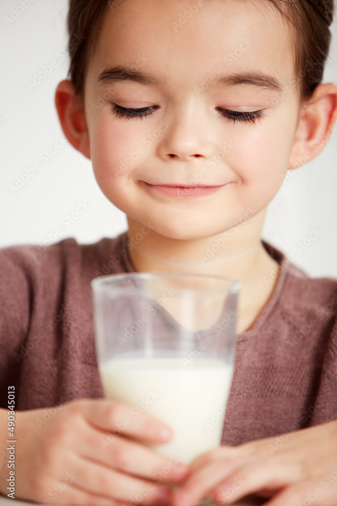 Mmmmmmmm milk. Cropped shot of a cute little girl looking happily at a glass of milk. Mmmmmmmm milk. Cropped shot of a cute little girl looking happily at a glass of milk.