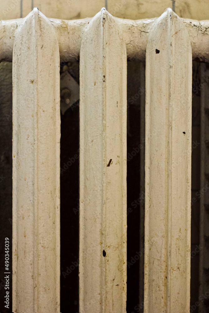 Old classic Radiator. Central heating in the house. Temperature control. Radiator on the wall in the house. Symmetry.