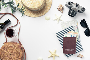 Top view travel concept with retro camera films, map, money and passport on white background with copy space. Flat lay tourist essentials