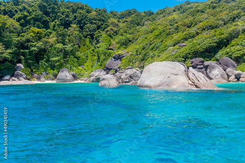 Landscape with green tropical lush rainforest and giant stones in turquoise water of Andaman Sea near Similan islands in Thailand.