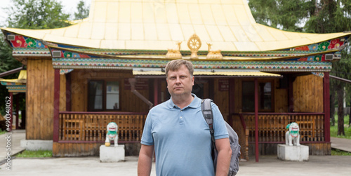 Obraz na plátně adult tall male blond tourist near the Buddhist temple datsan.