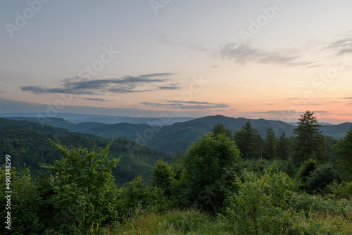 Aerial view of a beautiful evening summer landscape. Sunset and dusk in the mountains. Scenic photography from a drone. Location Carpathians, Ukraine, Europe. Natural landscape. Rest in the mountains.