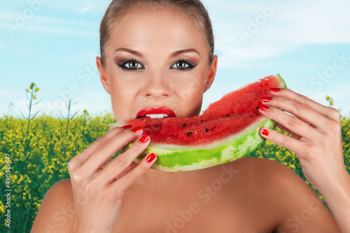 Girl holding slice of water...