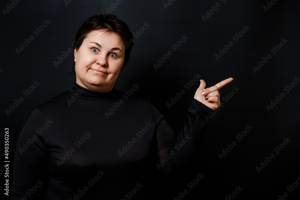 brunette woman pointing finger on black background brunette woman pointing finger on black background