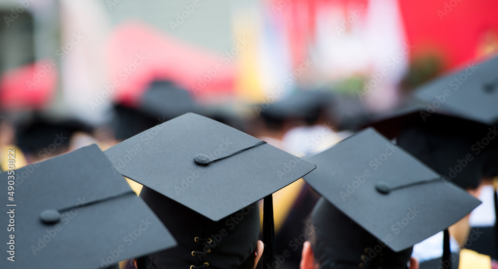 back of graduates during commencement. back of graduates during commencement.