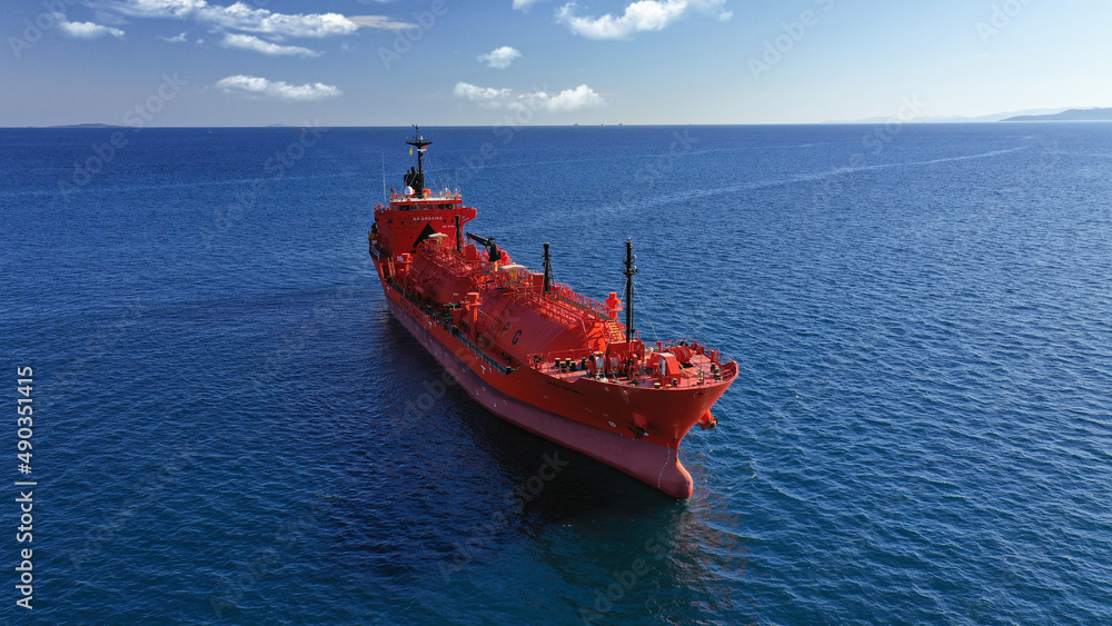 Aerial drone photo of large Liquefied Petroleum Gas tanker or LPG anchored in deep blue ocean sea Aerial drone photo of large Liquefied Petroleum Gas tanker or LPG anchored in deep blue ocean sea
