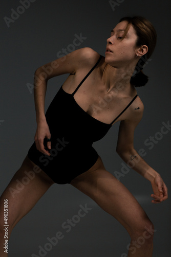 Beautiful and slim girl warming up on a white background © alexbutko_com