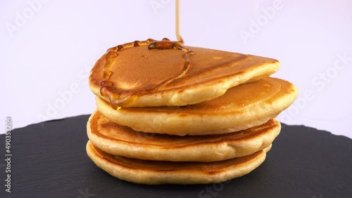Wallpaper Mural American pancakes with maple syrup on a white background. Pancake lies on a black slate round stone. Torontodigital.ca