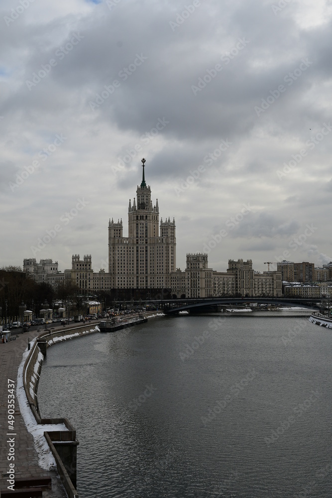 Panorama of the Moscow River and a view of a high-rise building. Cloudy winter day.