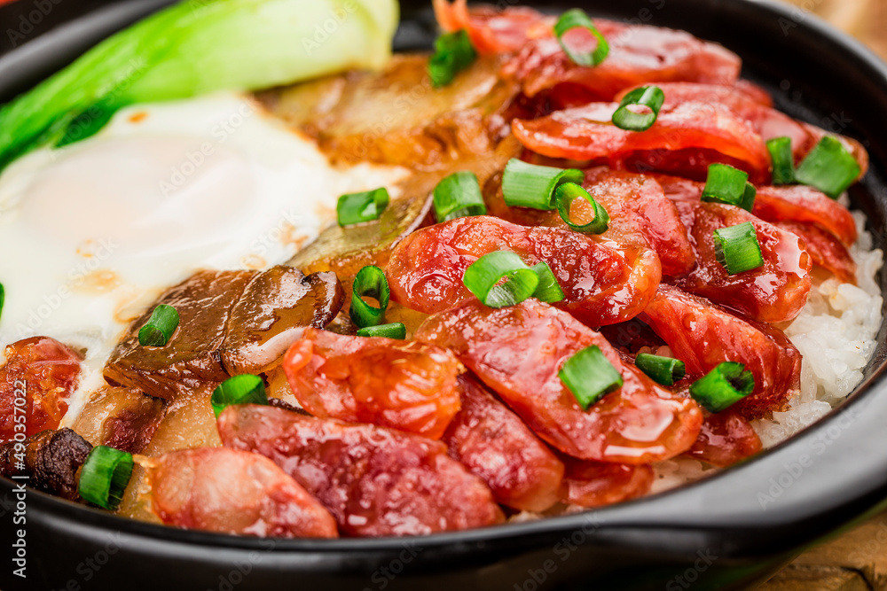 Cantonese style cooking of claypot rice with waxed meats Cantonese style cooking of claypot rice with waxed meats