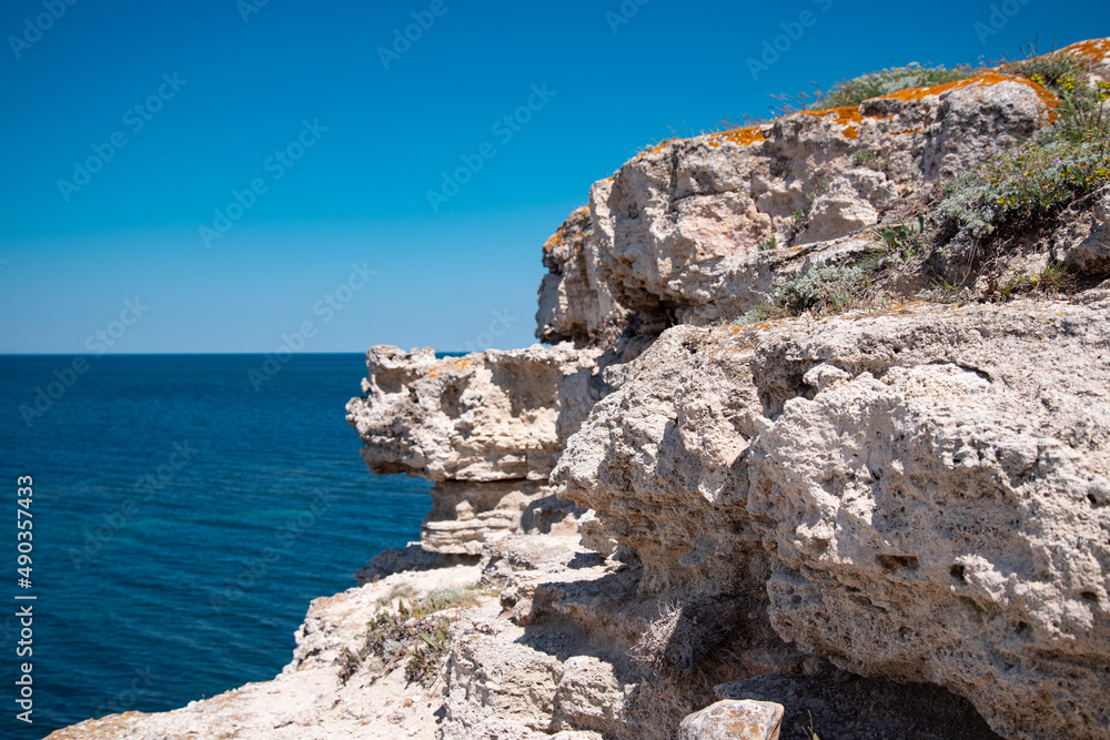 Beautiful white rocks on the background of the sea. Summer coastline landscape. Travel and holidays in the south.