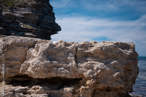 Stone mountains. Geological research near the sea. Natural background. Summer landscape.