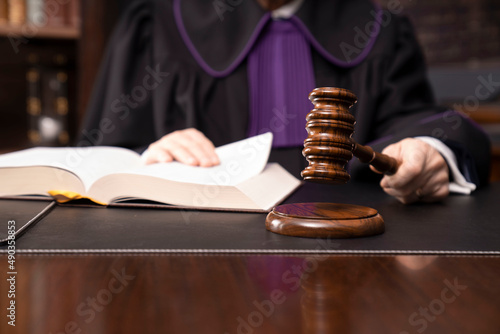 Law and justice  – judge in toga with the gavel during trial photo