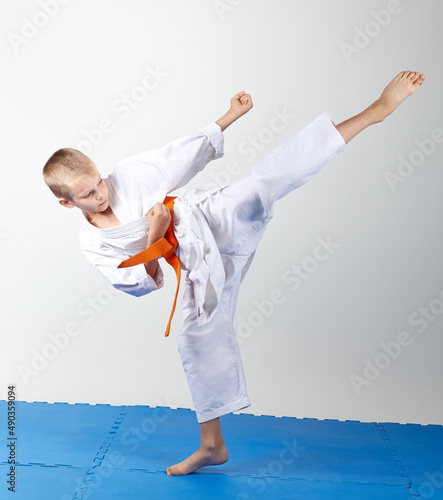 Mavashi geri beats athlete with an orange belt photo