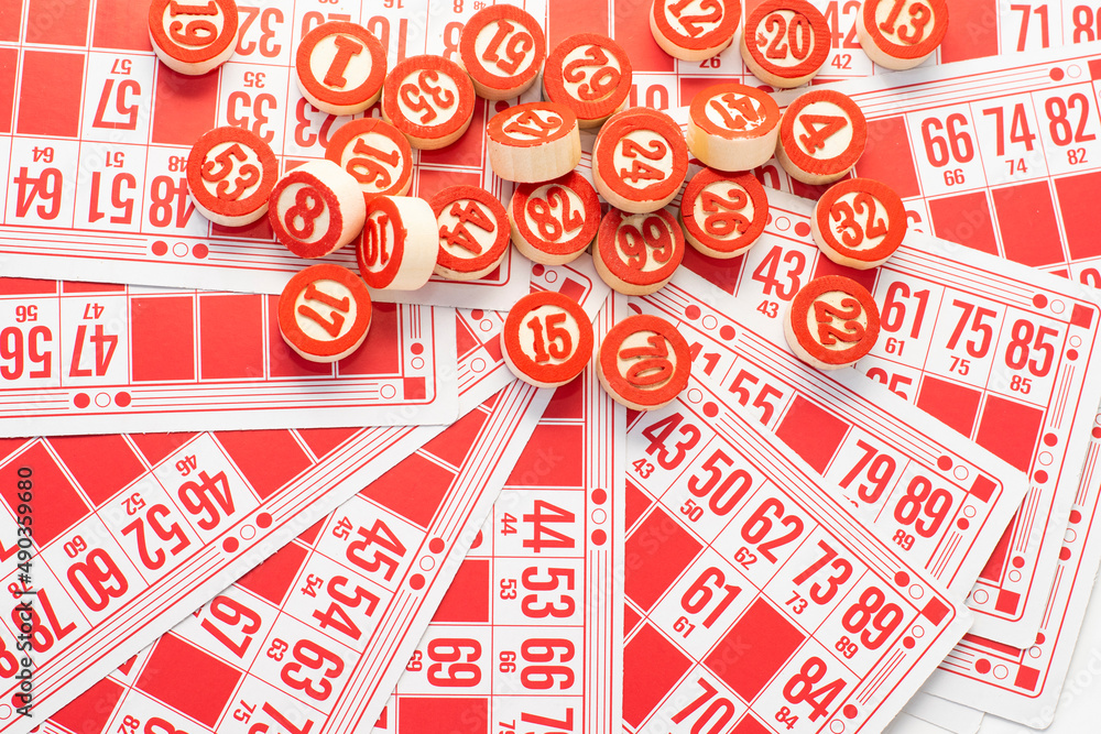 Red lotto cards and wooden barrels, tokens, counters with numbers on