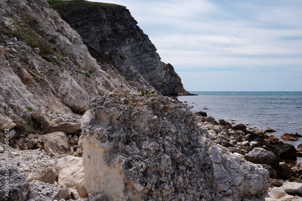 Stone mountains on the background of the sea landscape. Lime minerals. Geology near the ocean. Natural background. Stone mountains on the background of the sea landscape. Lime minerals. Geology near the ocean. Natural background.