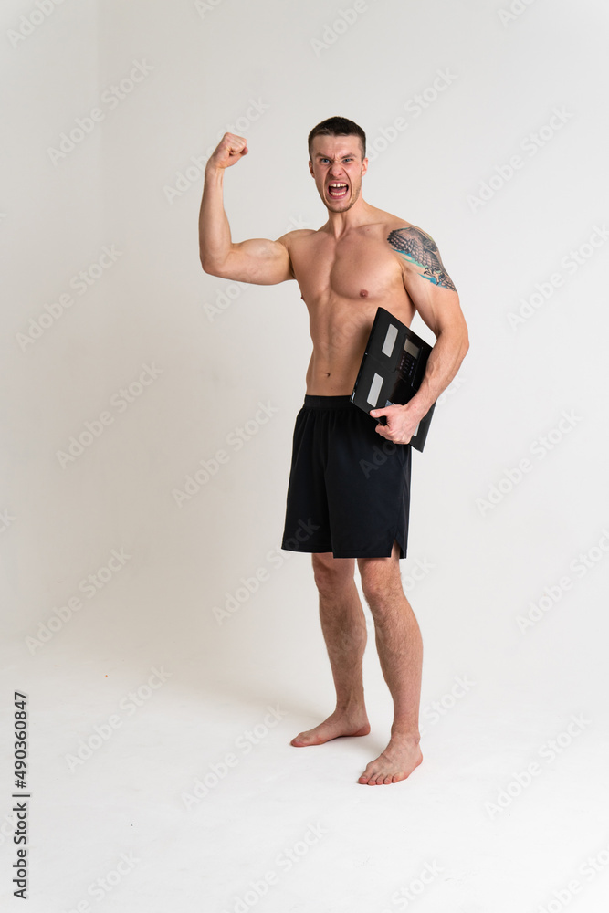 Fototapeta premium Man with weights health pondered, health and sports on a white background back hurt injury, cramp spine isolated young adult, illness expression. sickness, back suffer attractive