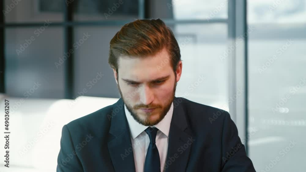 Serious man surfing the internet using a laptop. Young businessman with laptop Serious man surfing the internet using a laptop. Young businessman with laptop