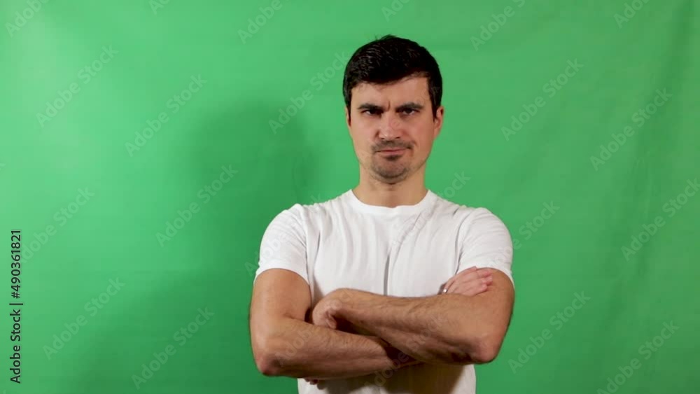 Handsome man disagrees and folding hands, isolated on green screen. Slow motion Handsome man disagrees and folding hands, isolated on green screen. Slow motion