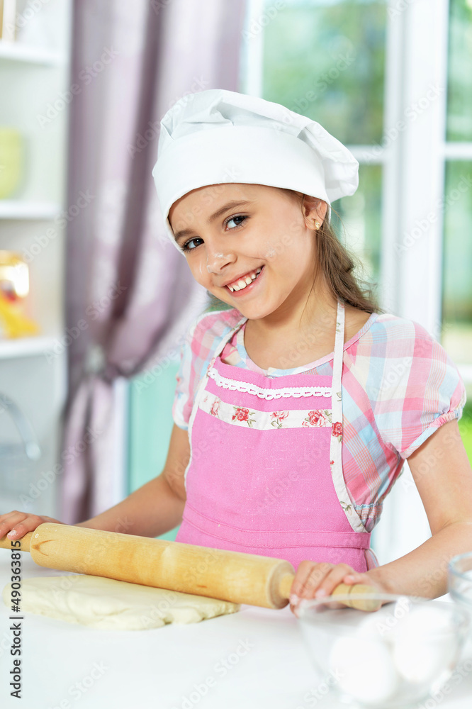 Cute girl making dough in the kitchen Cute girl making dough in the kitchen
