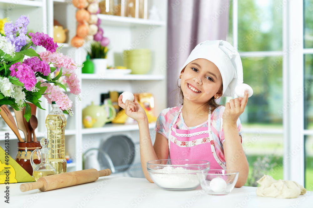 Cute girl making dough in the kitchen Cute girl making dough in the kitchen