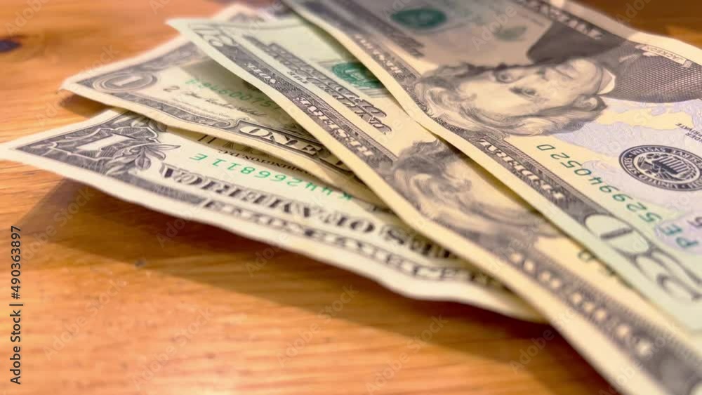 Counting a bunch of Dollar bills on a table - travel photography Counting a bunch of Dollar bills on a table - travel photography