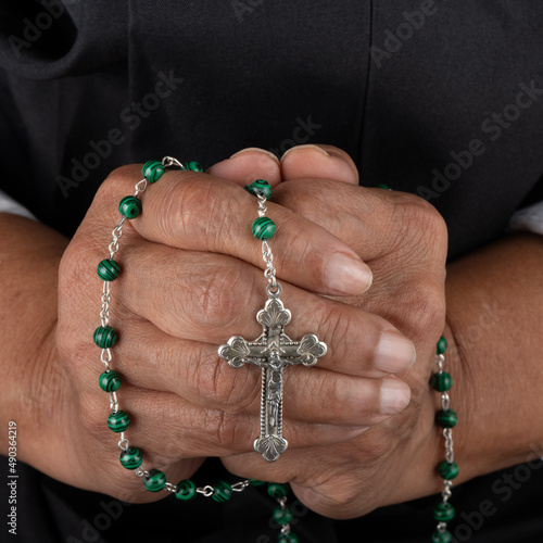 Hand holding rosary