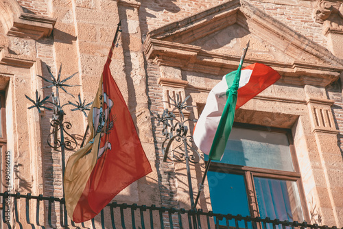 Waving Flags of Sicily, Italy, and Ue in the Ancient City Palace in Piazza Armerina, Sicily, Italy, Europe photo