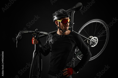 Fototapeta Naklejka Na Ścianę i Meble -  male cyclist with road bicycle on black background