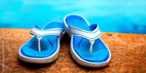 Sandals Flip Flops Next to Clear Swimming Pool Blue Water Fresh