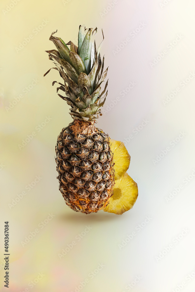 una piña entera con dos rodajas de piña cortadas y puestas detrás de la ...