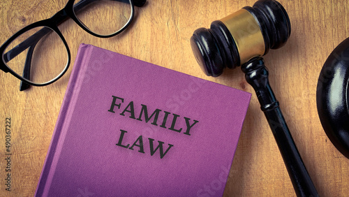 Family law and gavel on a table. With glasses background.