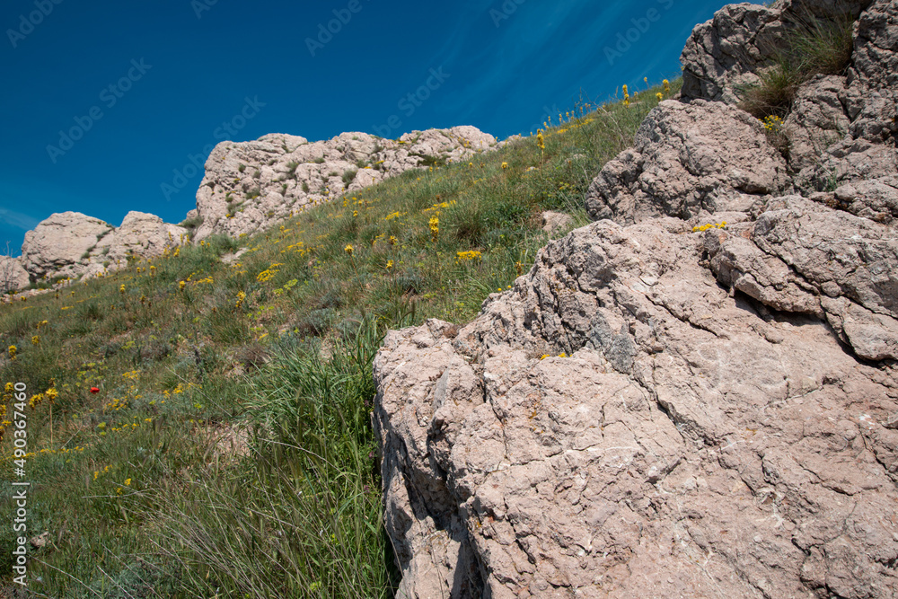 Beautiful mountain landscape. Journey in the spring. Green meadows against the blue sky. Beautiful mountain landscape. Journey in the spring. Green meadows against the blue sky.