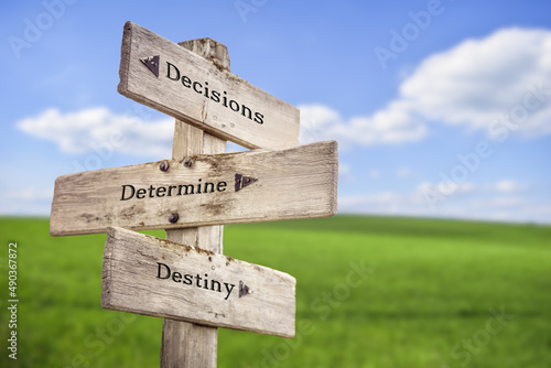 decisions determine destiny text quote on wooden signpost outdoors on green field with blue sky Fototapeta