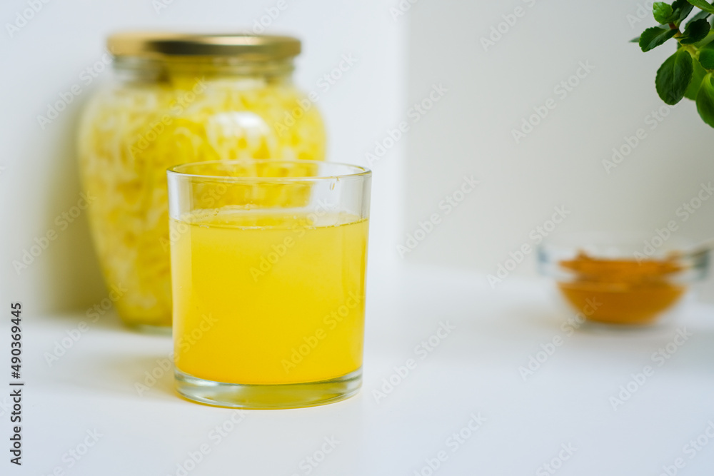 Fermented cabbage with turmeric. Cabbage kvass. Pickling vegetables without salt. Fermentation. Vitamin treatment and nutrition. Organic turmeric powder and green leaves of houseplant in a frame. Fermented cabbage with turmeric. Cabbage kvass. Pickling vegetables without salt. Fermentation. Vitamin treatment and nutrition. Organic turmeric powder and green leaves of houseplant in a frame.
