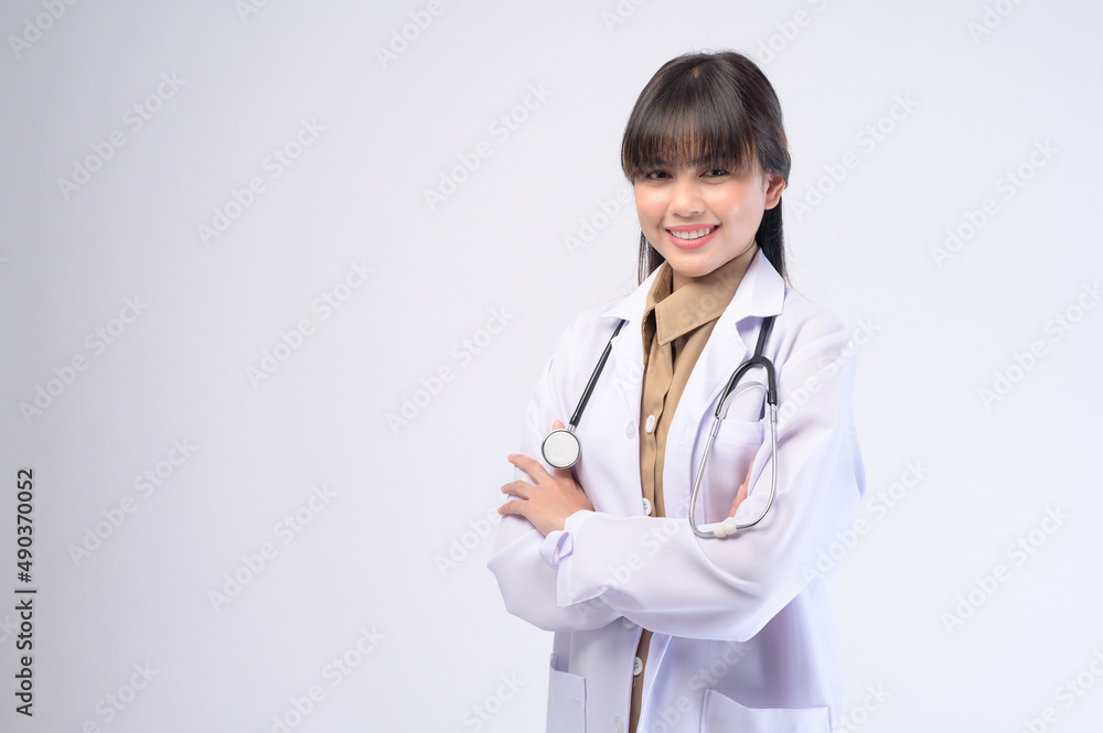 Young female doctor with stethoscope over white background Young female doctor with stethoscope over white background
