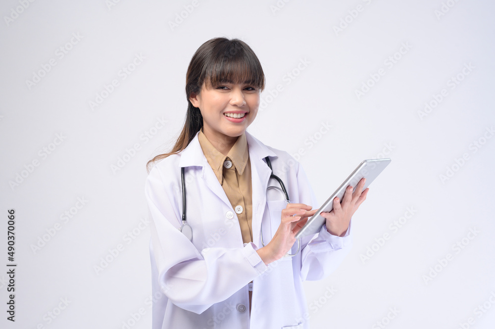 Young female doctor with stethoscope over white background Young female doctor with stethoscope over white background