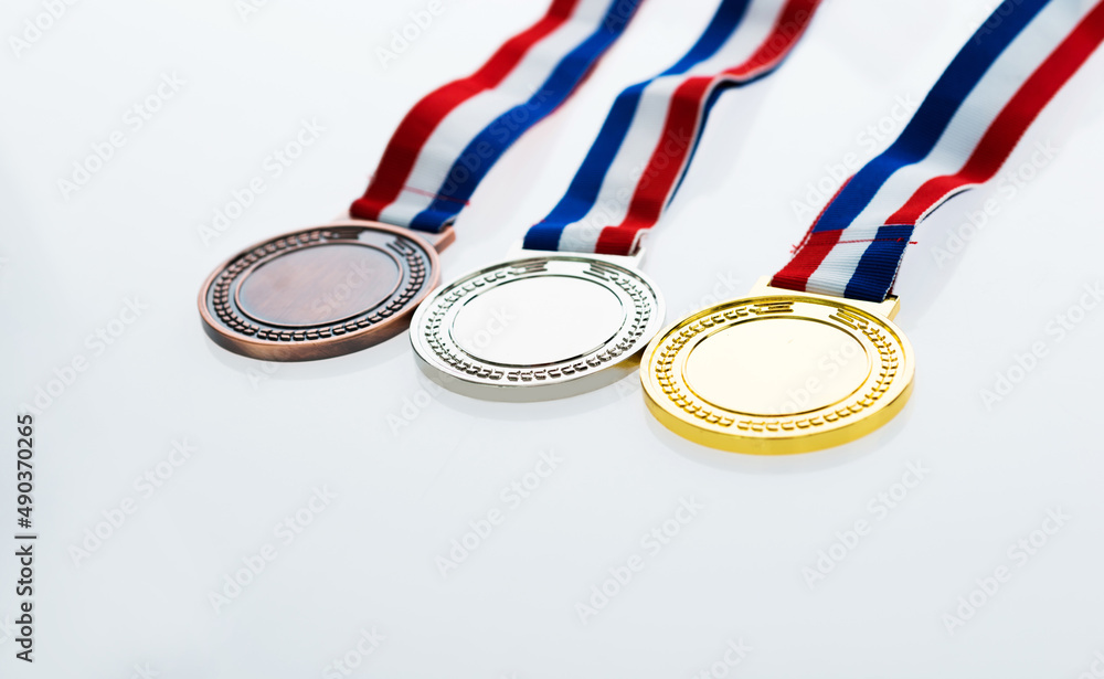 Set of gold silver and bronze award medals on wooden table Set of gold silver and bronze award medals on wooden table