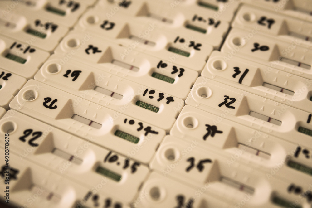 Rapid Antigen Test kit ATK with group people Negative result during swab for back to school, office working, university college COVID-19 test on table top view. Coronavirus Self Home Isolation concept