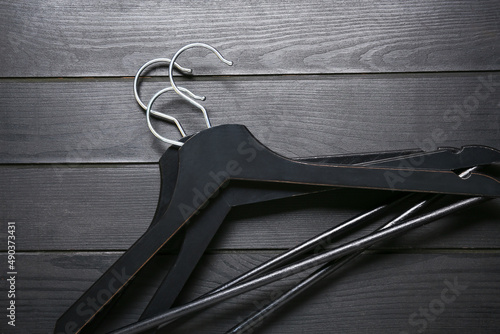 Clothes hangers on dark woo...