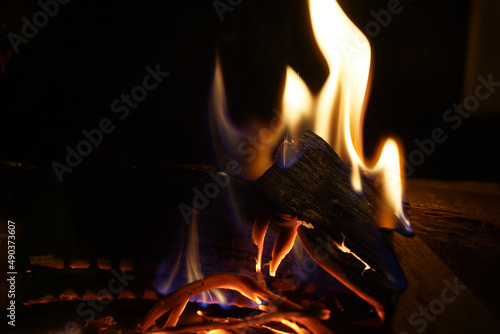 Fire burning wood to wood in the dark