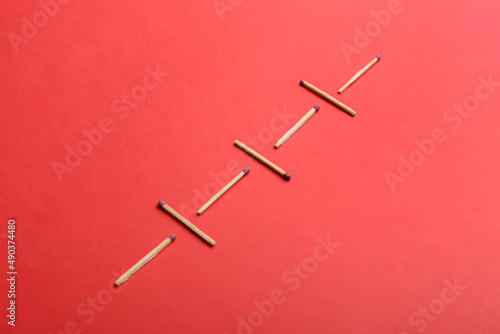 Whole matchsticks on red background. Social distancing concept